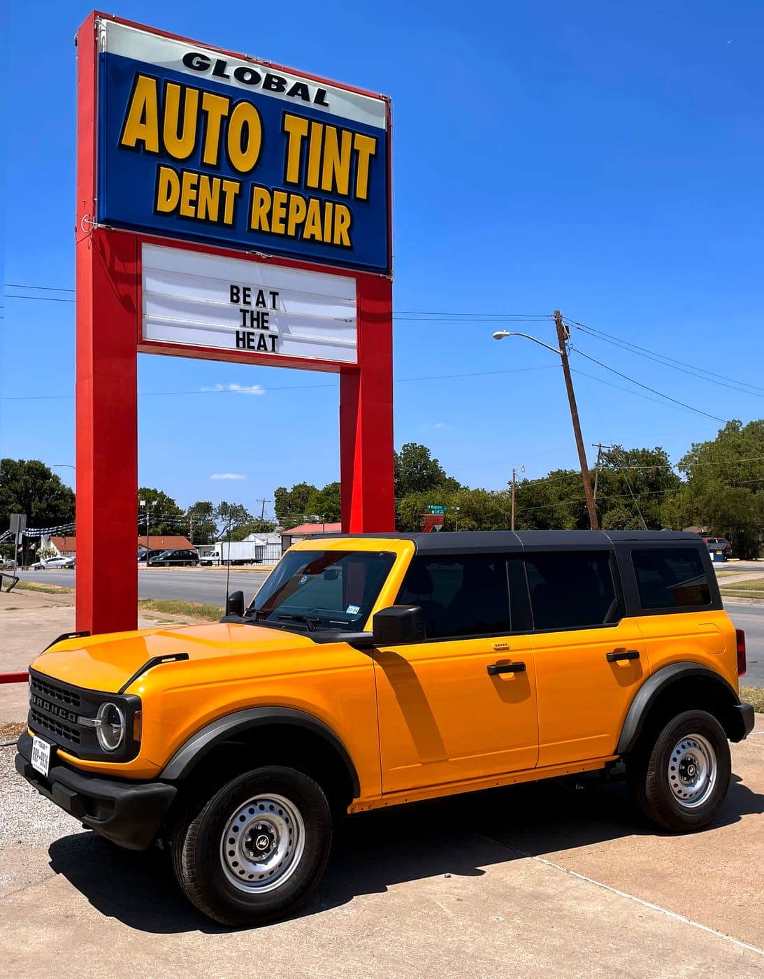 Ford Bronco under the Auto Tint sign