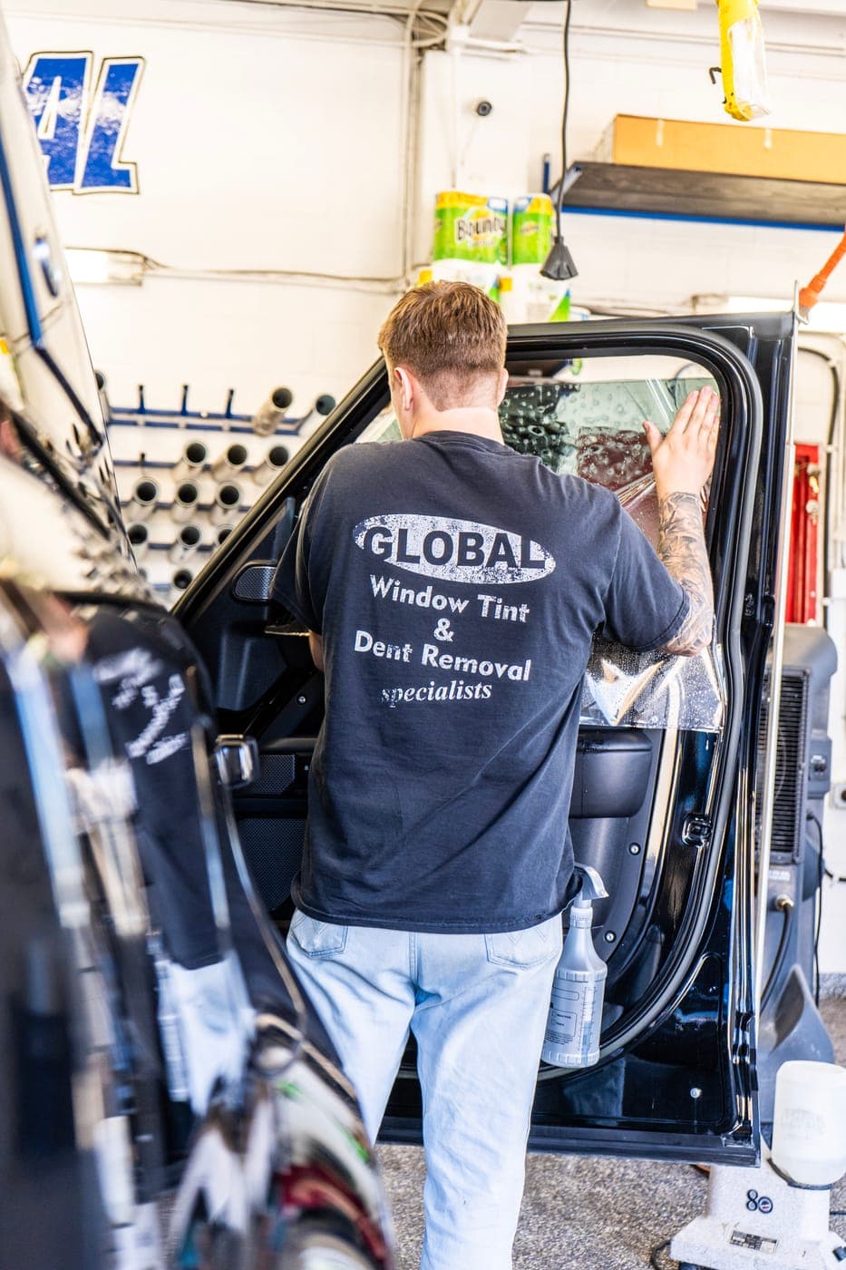 Working on a pickup door inside the shop