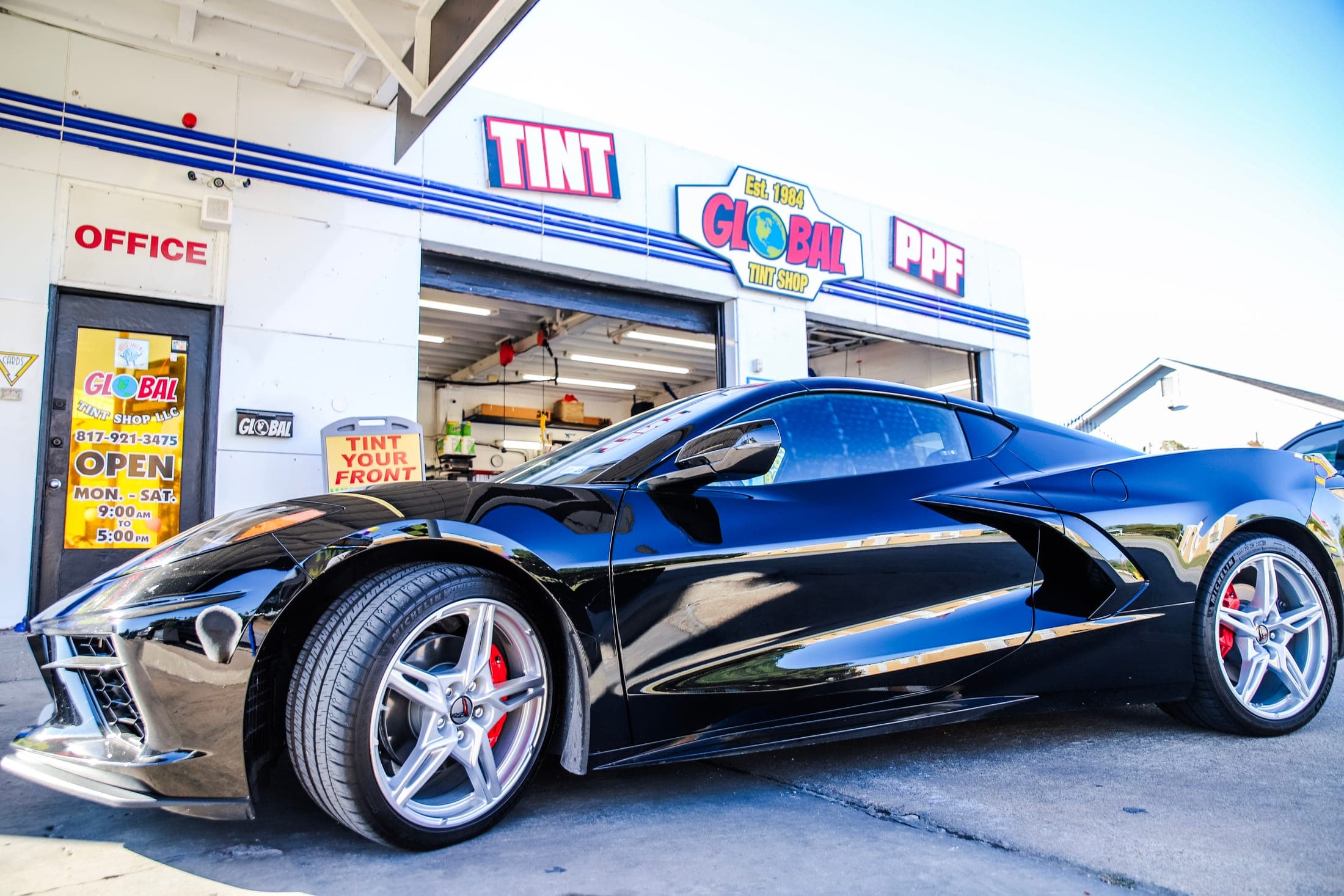 A black Corvette outside Global Tint on McCart Avenue